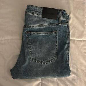 One pair of blue denim jeans.